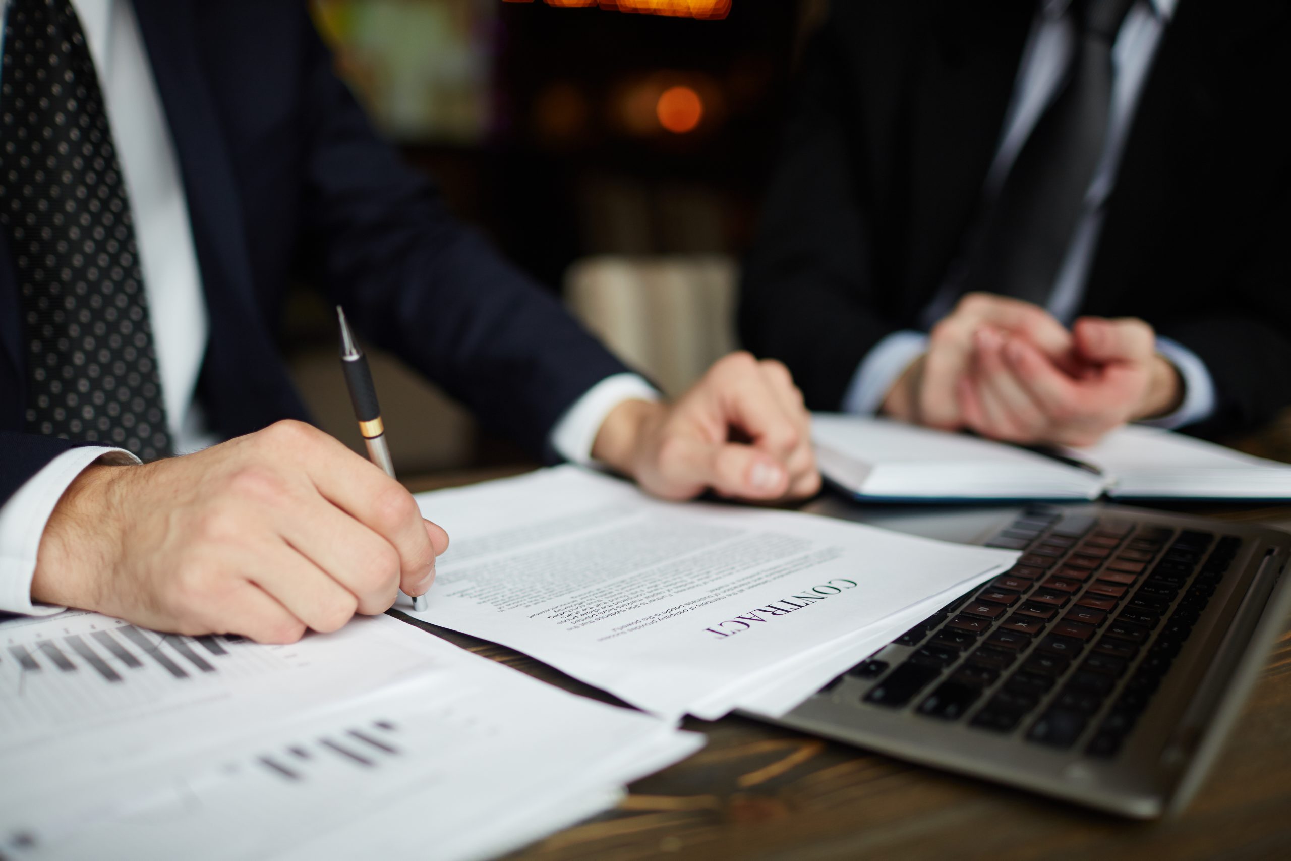 Professionals reviewing a contract related to the proposed Condominium Act reforms in Malta.