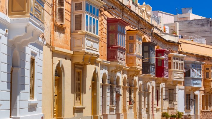 Traditional Maltese townhouses with colourful balconies, reflecting Malta’s architectural heritage and Victor Estate’s 60 years in the property industry.